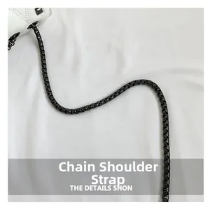 Detailed macro view of the black metal chain strap on a white quilted leather bag