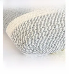Macro shot of handcrafted gray and beige woven rope texture on a beach basket bag