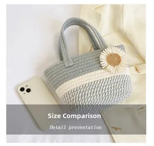 Macro detail of hand-woven striped tote bag with flower next to a smartphone for scale