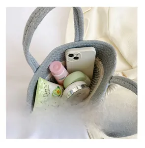 Interior view of grey woven bucket bag showing large capacity for phone and cosmetics