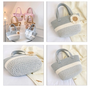 Close-up of handmade woven bucket bag featuring 3D daisy flower and satin bow detail