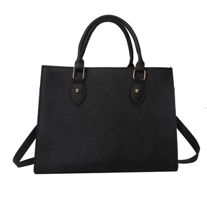 Minimalist black Saffiano leather tote bag with dual handles and gold-tone hardware