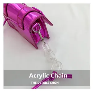 Detail of fuchsia metallic mini bag featuring a trendy Y2K acrylic chain strap handle