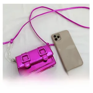 Hot pink mini crossbody bag with metallic mirror finish and transparent chain detail