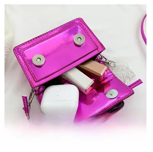 Internal view of metallic magenta mini bag showing capacity for lipstick and earphones