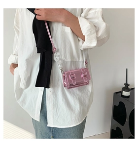 Detail of mini metallic pink satchel with clear acrylic chain and buckle closure