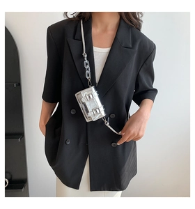 Silver mini square crossbody bag with decorative buckles and acrylic chain on model
