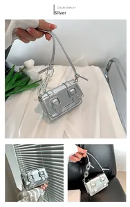 Detail view of silver mirror finish mini bag with acrylic chain and buckle closure