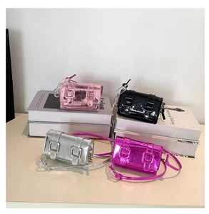 Detail view of four glossy mini square bags in pink, black, silver, and rose red colors
