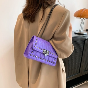Lavender quilted chain crossbody bag with metal rivets and a geometric turn-lock closure