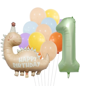 Close-up of olive green number 1 balloon and beige cartoon dinosaur for first birthday