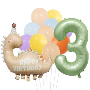 Detail of macaron dinosaur and number 3 foil balloons for child 3rd birthday party decor