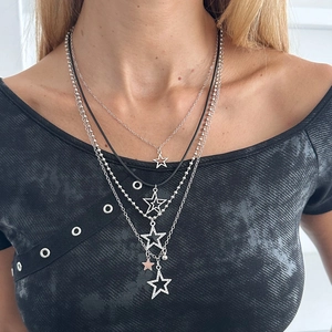 Layered punk necklace featuring silver stars and pearl accents on a black leather cord