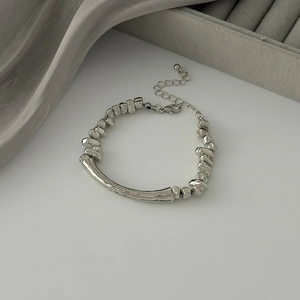 Detailed shot of irregular silver CCB beaded bracelet with organic curved metal tubes