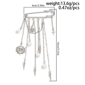 Detail view of silver tassel brooch with pearls, stars and charms, 6cm width by 14cm length