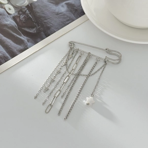 Silver safety pin brooch with multi-layered chain tassels and a white star pendant