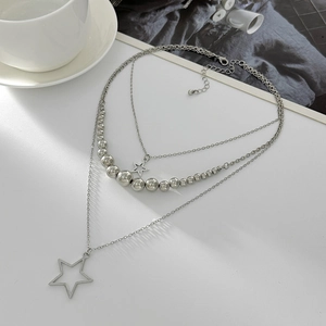 Detailed view of triple-layered silver star pendant necklace with beads and lobster clasp