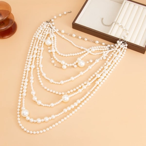 Detail view of multi-layer white pearl necklace with adjustable silver clasp and lobster hook