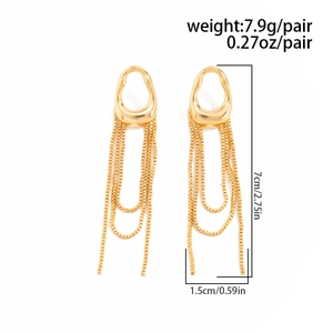Close-up of golden tassel clip earrings with box chain fringe and irregular wavy ring design