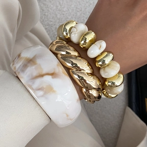 Three-piece set with marble resin bangle, gold rope cuff, and pearl bead bracelet