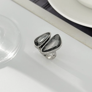 Detailed macro of vintage silver metal ring featuring dual grey asymmetric faceted crystals