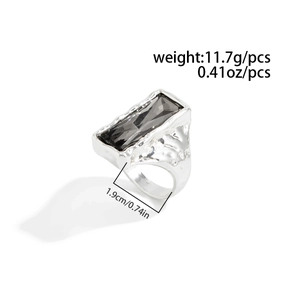 Close-up of industrial style silver ring with smoky grey rectangular faceted gemstone
