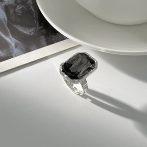 Close-up of a vintage geometric ring featuring a large rectangular grey acrylic stone