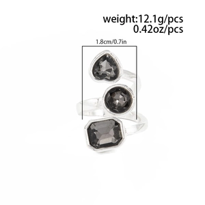 Detail view of silver triple-wrap ring with black gems, measuring 1.8cm wide and 12.1g weight