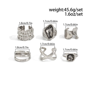 Close-up of a 6-piece silver vintage ring set with acrylic stones and geometric designs