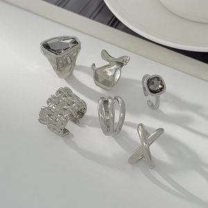 Set of six silver minimalist rings featuring geometric designs and black gemstones