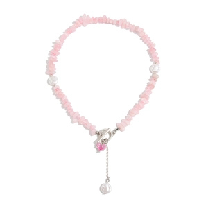 Pink gemstone and pearl necklace with heart pendant and toggle clasp on white background