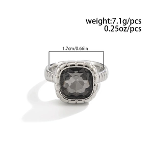 Close-up of geometric ring with grey acrylic gemstone and textured vertical stripes