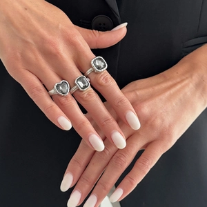 Detail of silver twisted rope rings with grey square and heart-shaped crystals