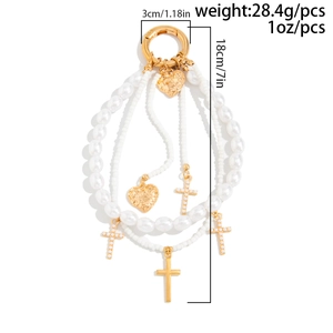 Detail view showing dimensions of multi-layer pearl cross keychain with heart charms