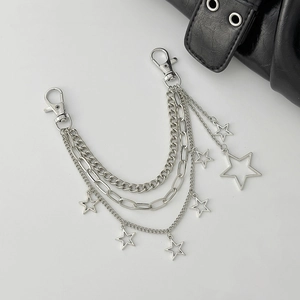 Macro shot of silver multi-layer metal chain with star pendants and lobster clasps