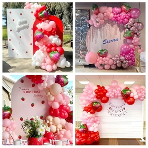 Detail of strawberry theme balloon arch set with red pink latex and foil balloons