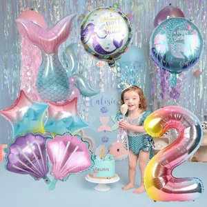 Close-up of mermaid tail foil balloons and sea shells for birthday party decorations