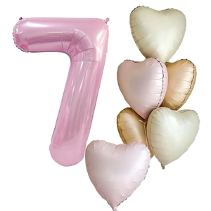 Macro detail of number 7 foil balloon with macaron heart balloons for birthday decor