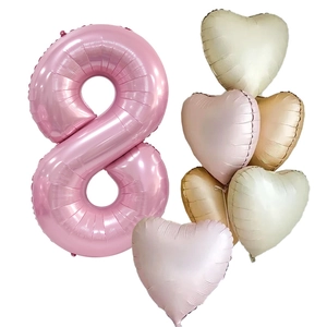 Detail of pink number 8 foil balloon with pastel heart balloons for birthday decor