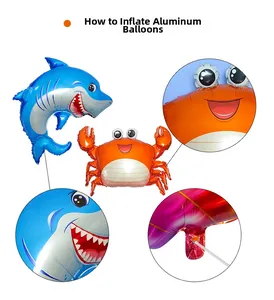 Detail of blue shark and orange crab foil balloons with inflation port close-up view