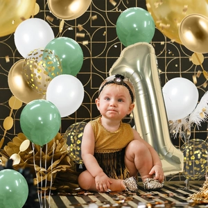Setup of sage green and gold number 1 balloon set for a first birthday party