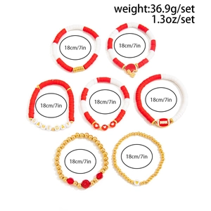 Close-up of a 7-piece rugby game day bracelet set with red clay beads and gold accents