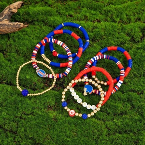 Detail of multi-layered Game Day beaded bracelets with football and helmet charms on moss