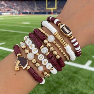 Detail of multi-layer Game Day bracelet set with rugby helmet charm and clay beads