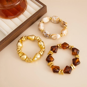 Detailed close-up of retro resin beads and gold hammered texture stretch bracelets set