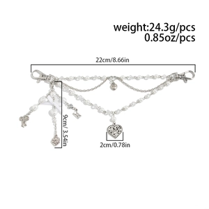 Detailed size chart of beaded bag charm featuring silver heart and pearl pendants