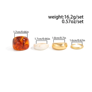Flat lay of four-piece retro resin and gold alloy rings with sizing and weight details