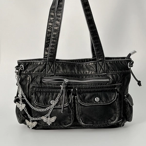 Detail view of black PU leather bag with butterfly metal chain and zipper pockets
