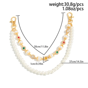 Detail of double-layer pearl bag chain with colorful gemstone flowers and gold lobster clasps