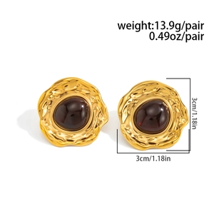 Detail view of retro geometric gold earrings with tiger eye stone and 3cm diameter mark